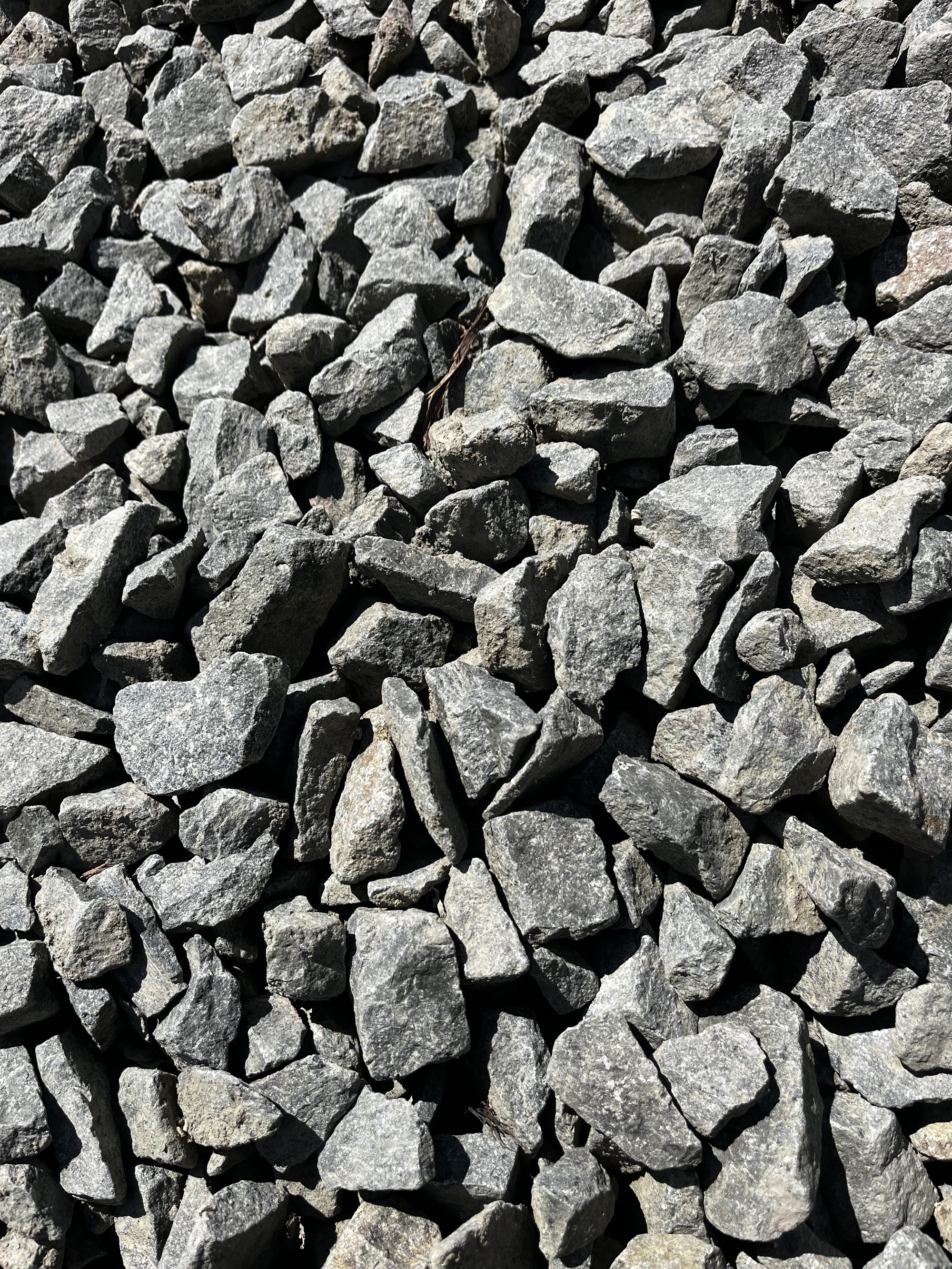 Black and grey crushed granite. Fractured angular landscape rock.